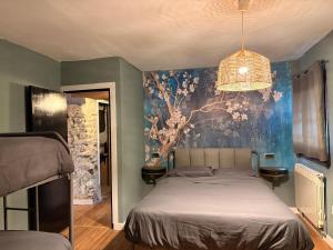 a bedroom with a bed and a painting on the wall at Camping Ripolles in Ripoll +105 photos