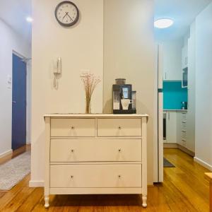 a dresser in a room with a clock on the wall at Casa de Burgh in Turner
