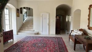 a living room with a couch and a rug at Csillaghy Kastély in Bókaháza