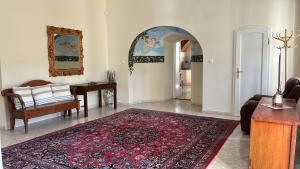 a living room with a rug on the floor at Csillaghy Kastély in Bókaháza