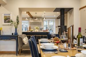 a dining room with a table and a stove at Beckside in Kettlewell