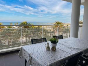 a table on a balcony with a view of the ocean at RIVIERA PALACE - BILO SEA FRONT- Premium Villas in Giulianova