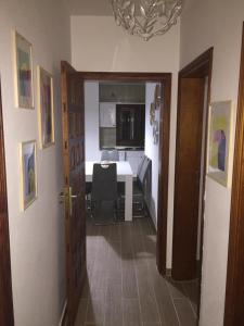 a room with a desk and a table with a computer at Casa Corralejo a 40 m playa in Corralejo
