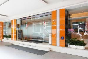an entrance to a car dealership with orange doors at CityInn Hotel Taipei Station Branch III in Taipei