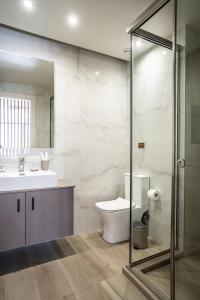 a bathroom with a toilet and a sink at Bedspot Heraklion in Heraklio