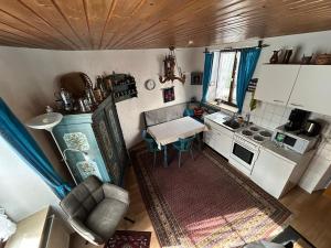 an overhead view of a small kitchen with a couch and a table at Turm an der Mauer in Ellwangen