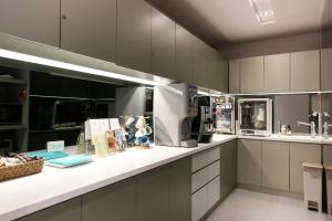 a large kitchen with white cabinets and appliances at CityInn Hotel Taipei Station Branch III in Taipei