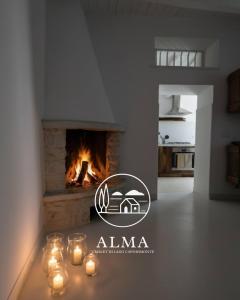 a living room with a fireplace with candles on a table at Alma Capodimonte Lake chalet in Capodimonte
