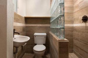 a bathroom with a toilet and a sink at Surfers Bay in Christ Church +16 photos