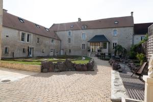 a large stone building with a garden and a courtyard at la Bastide du Laizon & Spa in Maizières