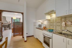 a kitchen with a sink and a stove top oven at Villa Eva: Leggiuno 5-Bed Villa for Families & Groups (Sleeps 10) - Happy Rentals in Leggiuno