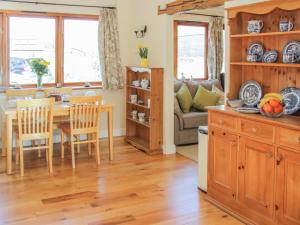 a kitchen and dining room with a table and chairs at Herdwick Cottage in Much Wenlock