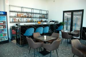 a bar with chairs and tables in a restaurant at Hotel Iliria in Golem