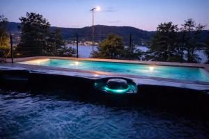a swimming pool with a light in the water at Domusigua in Gérardmer