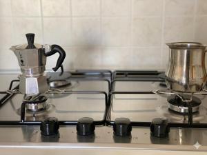 a stove top with a tea kettle on it at TRIESTE - Premium Villas in Giulianova +1 photo
