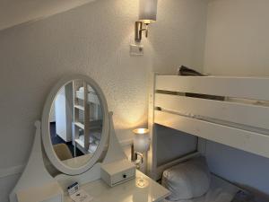 a bathroom with a mirror and a white sink at Gästehaus Elzblick in Rust