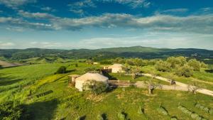 an aerial view of a farm with tents in a field at 2 CUORI E 1 YURTA Glamping in Tuscany - Adults Only in Asciano