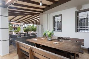 a dining room with a wooden table and benches at Villa Beta 2 - 3min walk to Elephant and Mako in Pefkochori