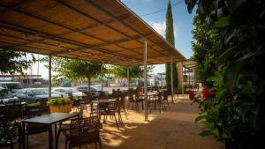 a row of tables and chairs under a pavilion at Hotel Puerta de la Serrania in Lliria