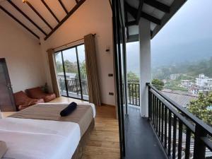 a bedroom with a bed and a balcony with a view at Lipton View Inn near Ella & Haputhale in Bandarawela