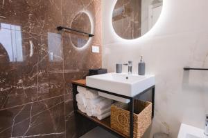 a bathroom with a sink and a mirror at ARQO Apartments in Marcianise +71 photos