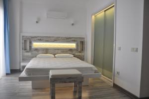 a bedroom with a bed and a bench in it at Nur Hotel in Kaş