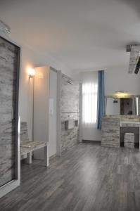 an empty room with a table and a kitchen at Nur Hotel in Kaş