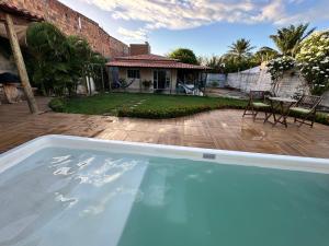 a large swimming pool in front of a house at Casa Verano dHebron in Camaçari