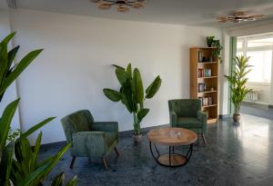 a living room with two chairs and a table at Gästehaus am Räuschenberg in Höxter