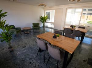 a room with two wooden tables and chairs in it at Gästehaus am Räuschenberg in Höxter
