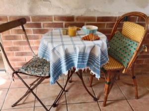 a table with a blue and white table cloth and chairs at la halte in Dampierre
