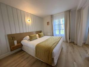 a bedroom with a large bed and a window at Le Cap Hornu in Saint-Valéry-sur-Somme +36 photos