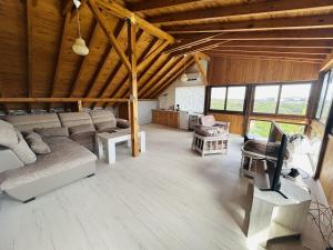 a large living room with a couch and a desk at Heaven's Home in Topola