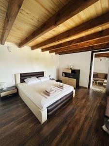 a bedroom with a large bed and wooden ceilings at Heaven's Home in Topola +19 photos