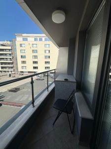 a balcony with a chair and a view of a building at GALAXY apartment in Sofia