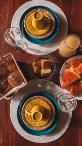 a table with plates of food on top at Pousada Cajuzinho do Cerrado in Cavalcante