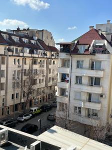 a view of a city with buildings and a bus at GALAXY apartment in Sofia