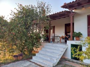 a man sitting on the porch of a house at tragano in Traganón