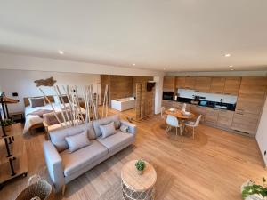 a living room with a couch and a bedroom at Le Loft des Crêtes in Dinant