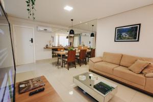 a living room with a couch and a table at LRFlat 3 - Flat para pessoas exigentes com requinte e conforto próximo de tudo! Garagem e portaria 24h in Montes Claros