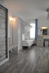 a large white room with a bed and a couch at Nur Hotel in Kaş