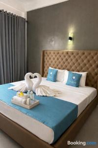 a bedroom with a bed with swans in the middle at Pearl Diamond Resort in Trincomalee +43 photos