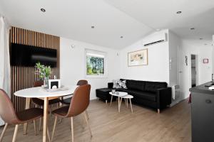 a living room with a black couch and a table at First Camp Lunde - Telemark in Lunde