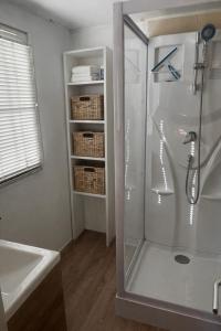 a shower with a glass door in a bathroom at Le Mas de L intention La Class Act in La Crau