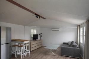 a living room with a couch and a table at Le Mas de L intention La Class Act in La Crau