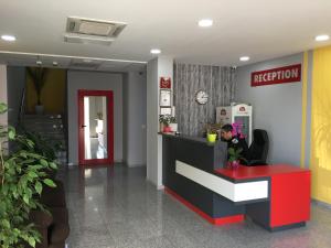 a lobby with a reception desk in a hospital at Hotel Iris in Plovdiv