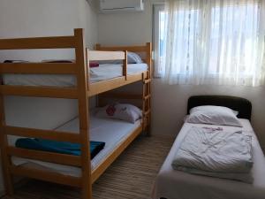 a small room with two bunk beds and a window at Guest House LEA in Mostar