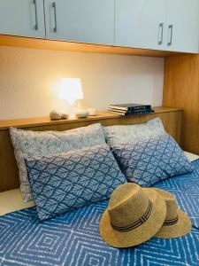 two hats sitting on top of a bed at Contessa robinson house in Korčula