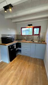 a kitchen with a sink and a counter top at Stone Tiny Chalten Nordic Cabin Patagonia - Arg in El Chalten