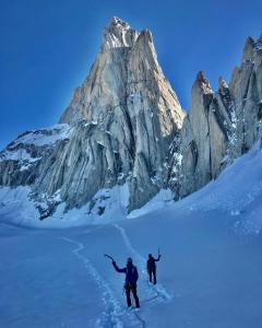 two people on skis in front of a mountain at Stone Tiny Chalten Nordic Cabin Patagonia - Arg in El Chalten